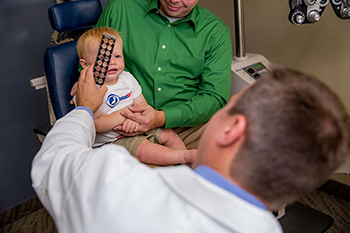 Doctor conducting eye exam on an infant