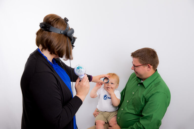 Woman performing eye exam on a child